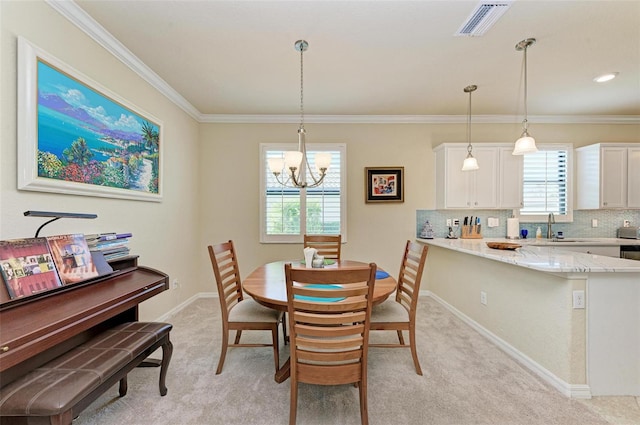 carpeted dining room with an inviting chandelier, sink, and crown molding