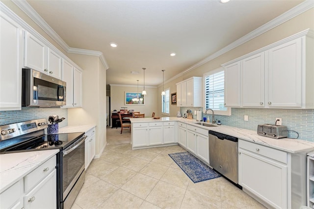 kitchen with sink, white cabinetry, stainless steel appliances, pendant lighting, and ornamental molding