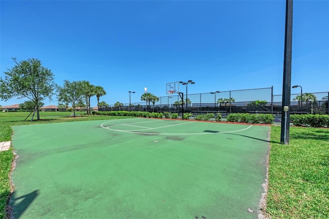 view of basketball court featuring a lawn