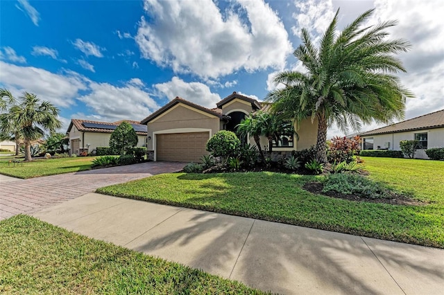 6547 Willowshire Way, Bradenton, FL 34212 - view of front facade featuring stucco siding, decorative driveway, a garage, and a front lawn