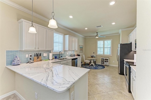 6547 Willowshire Way, Bradenton, FL 34212 - kitchen with range with electric stovetop, dishwasher, a sink, white cabinetry, and backsplash