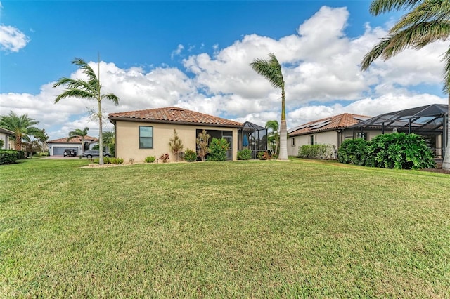 6547 Willowshire Way, Bradenton, FL 34212 - back of property featuring a tile roof, a lawn, stucco siding, and a lanai