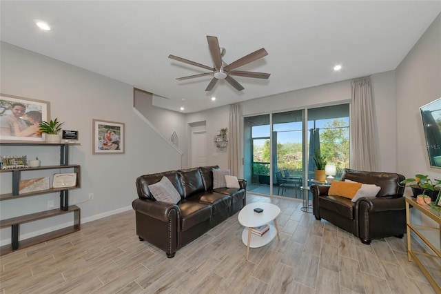 living room featuring light hardwood / wood-style floors and ceiling fan