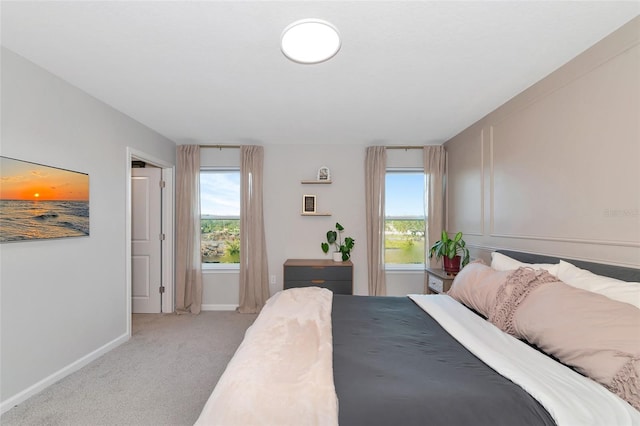 bedroom featuring light carpet