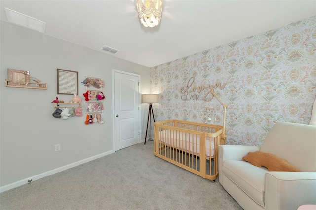 carpeted bedroom with a crib