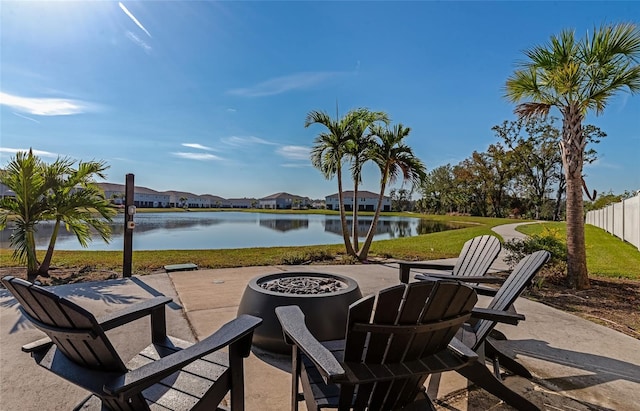 view of patio / terrace featuring an outdoor fire pit and a water view