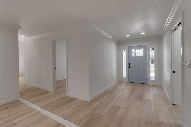 entryway with ornamental molding and light wood-type flooring