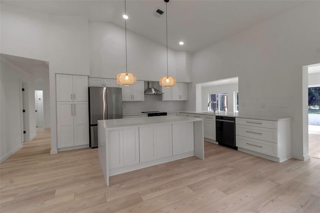 kitchen with wall chimney range hood, black appliances, pendant lighting, light wood-type flooring, and high vaulted ceiling