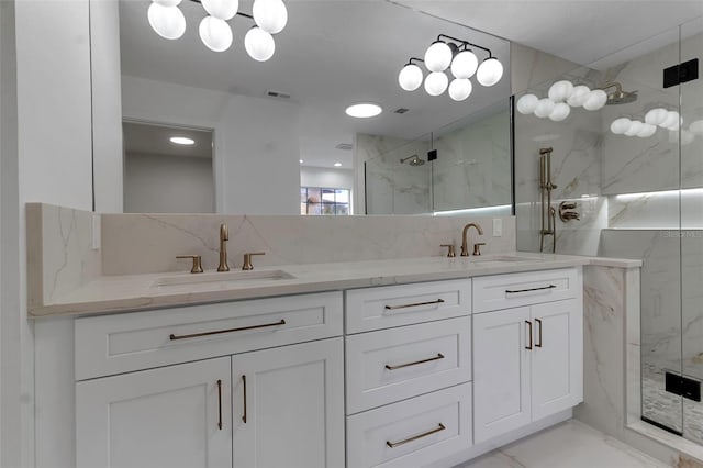 bathroom featuring a shower with door, vanity, and backsplash