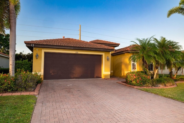 mediterranean / spanish-style house with a garage