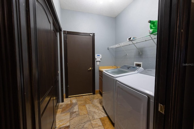 washroom featuring cabinets and separate washer and dryer