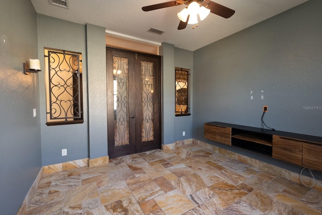 interior space featuring french doors and ceiling fan