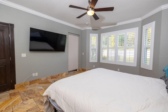 bedroom with ceiling fan, a textured ceiling, and crown molding