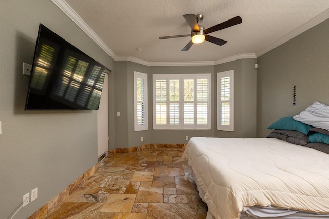 bedroom with a textured ceiling, ceiling fan, and crown molding