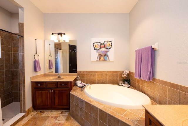 bathroom with vanity and independent shower and bath