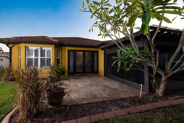 property entrance with a patio area