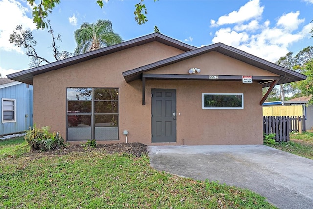 bungalow-style home with a front lawn