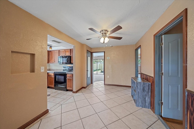 kitchen with ceiling fan, black appliances, and light tile patterned flooring