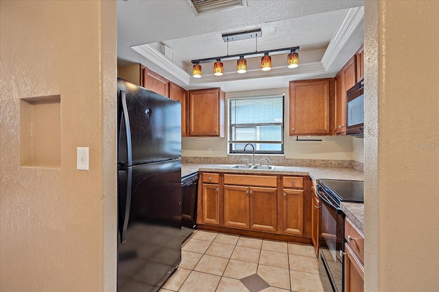 kitchen with hanging light fixtures, light tile patterned flooring, black appliances, crown molding, and sink