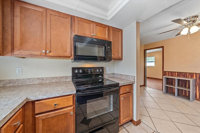 kitchen featuring ceiling fan, black appliances, light tile patterned floors, and ornamental molding