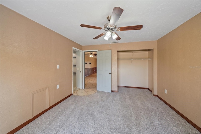 unfurnished bedroom with a closet, ceiling fan, and light carpet