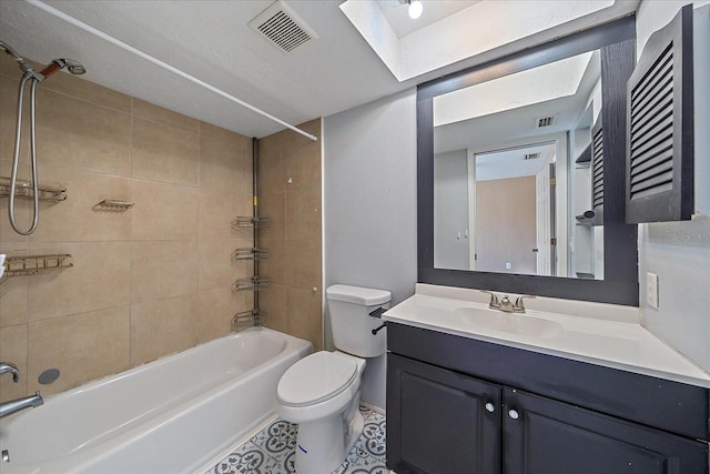 full bathroom featuring vanity, tiled shower / bath combo, toilet, and a skylight