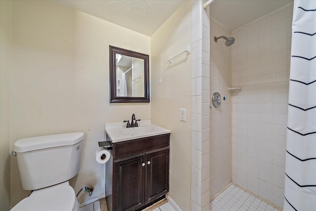 bathroom featuring vanity, toilet, a textured ceiling, and curtained shower