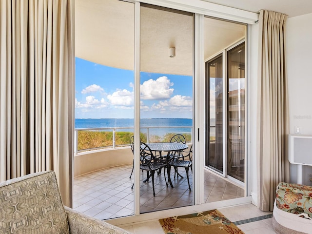 sunroom / solarium featuring a water view