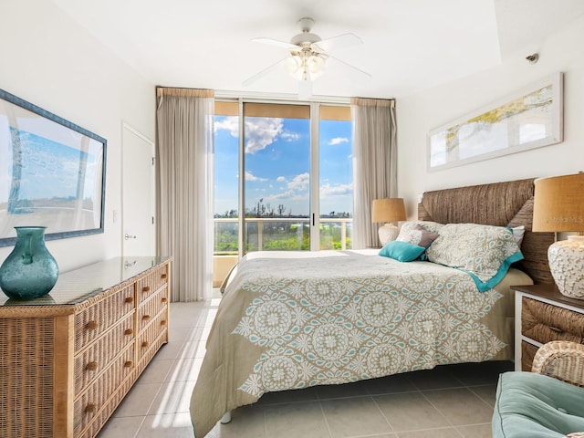 tiled bedroom with ceiling fan and floor to ceiling windows