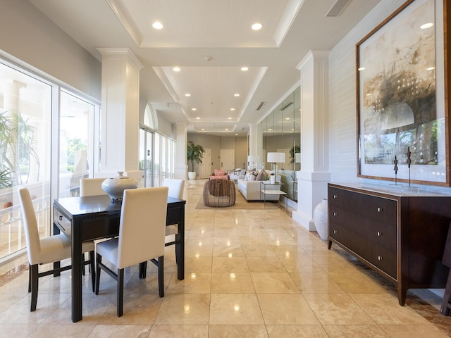 tiled dining space with a raised ceiling