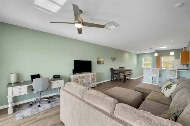 living room featuring hardwood / wood-style flooring and ceiling fan