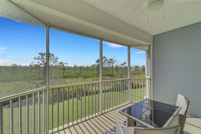 unfurnished sunroom featuring ceiling fan