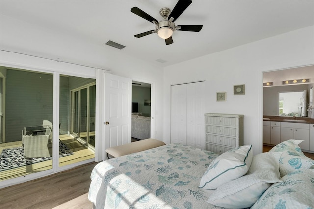 bedroom with ceiling fan, access to exterior, wood-type flooring, a closet, and sink