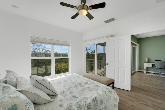 bedroom featuring access to exterior, wood-type flooring, and ceiling fan