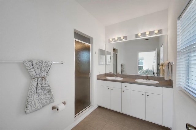 bathroom featuring vanity, a shower with shower door, and tile patterned flooring