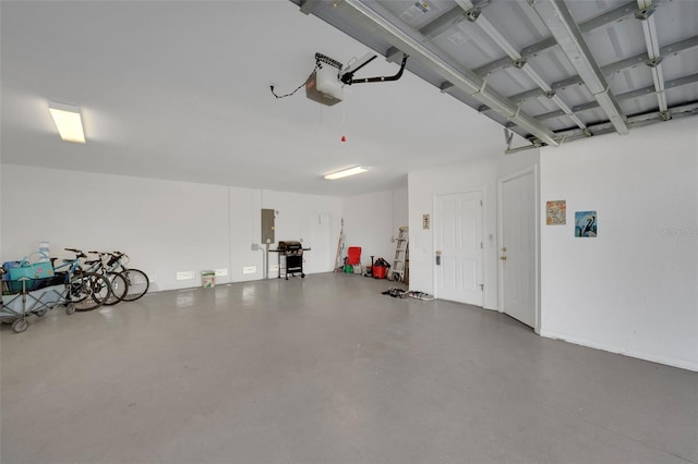 garage featuring a garage door opener and electric panel