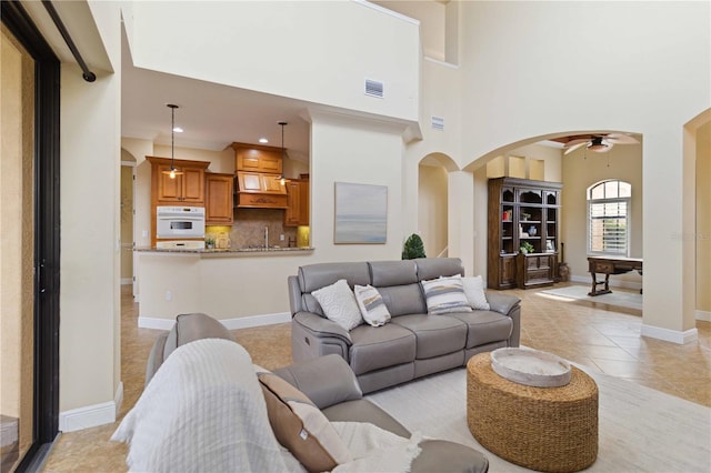 living room featuring pool table, ceiling fan, and light tile patterned floors