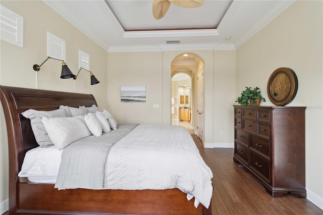 bedroom with ceiling fan, a raised ceiling, dark hardwood / wood-style flooring, and ornamental molding