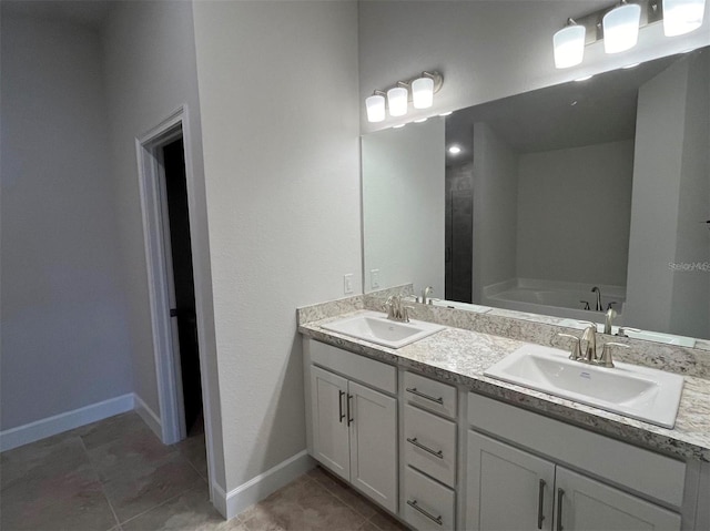 bathroom featuring vanity, tile patterned floors, and a bathtub