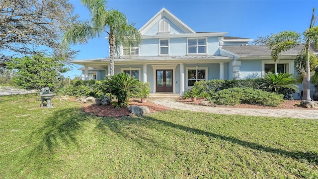 view of front of property with covered porch and a front lawn