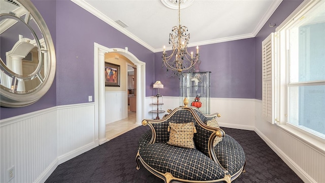 dining space with ornate columns, carpet flooring, ornamental molding, and a chandelier