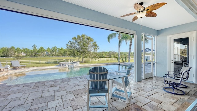 view of patio featuring a fenced in pool and ceiling fan