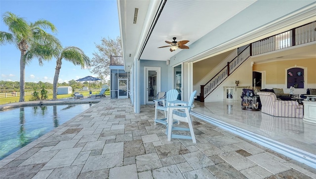 view of patio / terrace featuring a balcony and ceiling fan