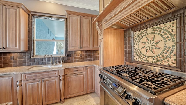 kitchen featuring tasteful backsplash, light stone countertops, sink, stainless steel stove, and ornamental molding