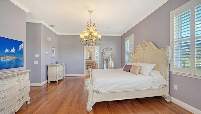 bedroom with multiple windows, ornamental molding, a notable chandelier, and wood-type flooring