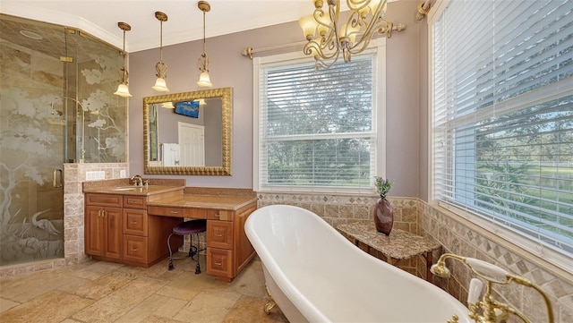 bathroom with vanity, independent shower and bath, a chandelier, and a healthy amount of sunlight