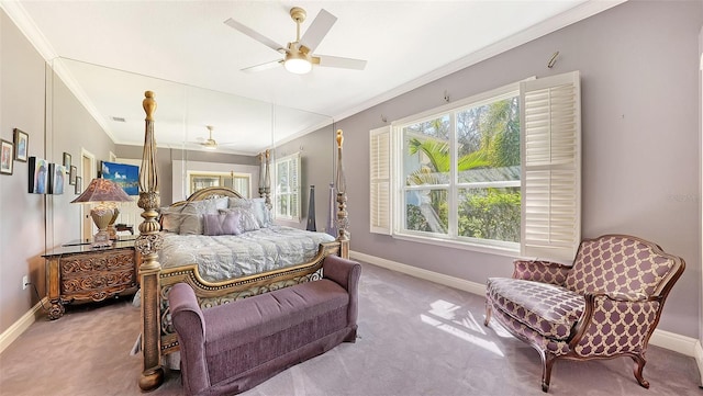 carpeted bedroom with ornamental molding and ceiling fan