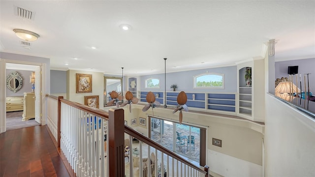 hall featuring dark wood-type flooring and ornamental molding