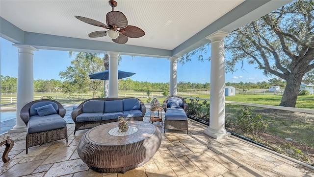 sunroom featuring ceiling fan and a wealth of natural light