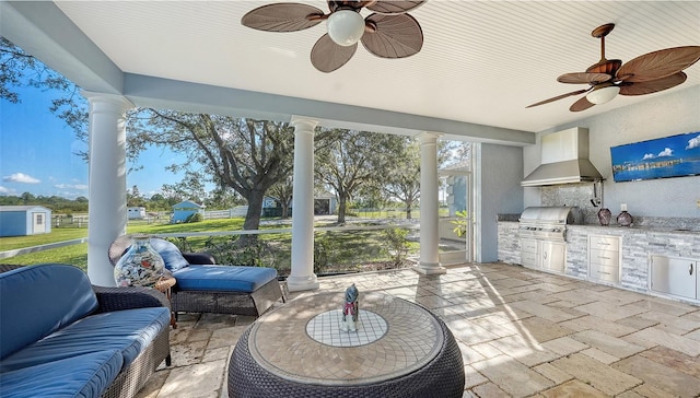 sunroom / solarium with ceiling fan and decorative columns